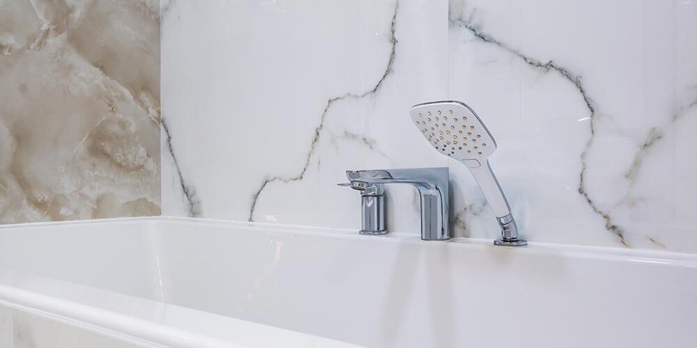 A brightly lit bathroom highlighting a glossy white tub after professional bathtub reglazing
